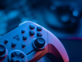Close-up of a video game controller with blue lighting