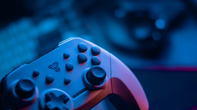 Close-up of a video game controller with blue lighting