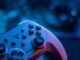 Close-up of a video game controller with blue lighting