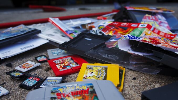 a bunch of nintendo games laying on the ground