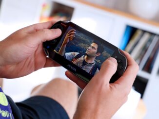 a man holding a smart phone up to his face