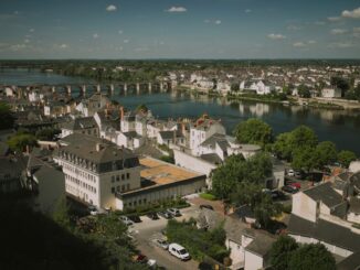A scenic view of a european town by the river.