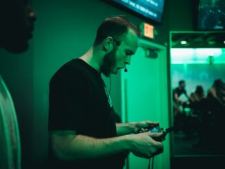 man holding game pad while shouting inside room