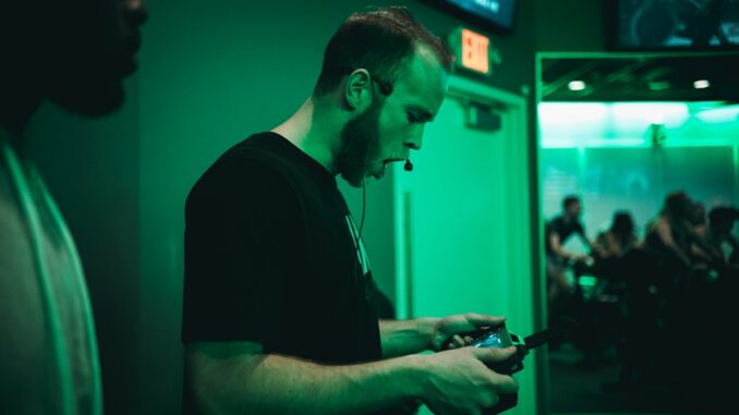 man holding game pad while shouting inside room