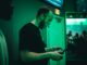 man holding game pad while shouting inside room