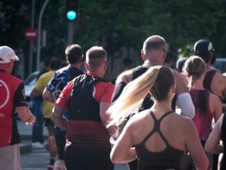 A group of people running in an urban marathon.