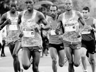 a group of men running down a street