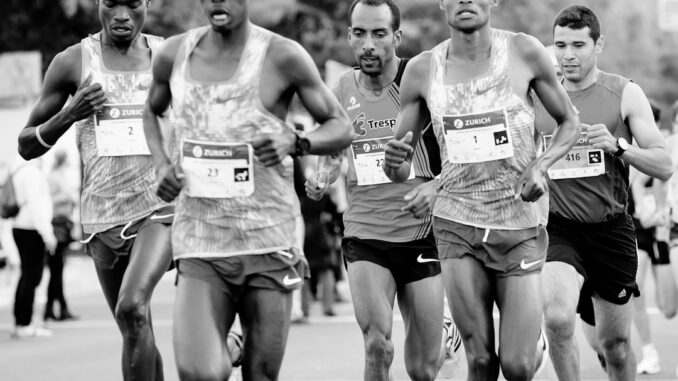 a group of men running down a street