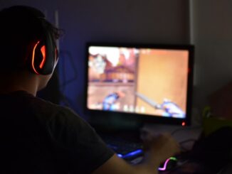A man wearing headphones playing a video game