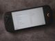 A handheld console displays language options.