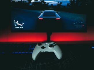 a video game controller sitting in front of a monitor