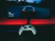 a video game controller sitting in front of a monitor