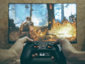 Hands holding a game controller playing a video game.