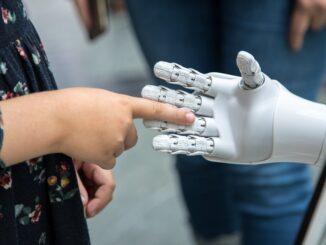 a person holding a robotic hand in front of a mirror