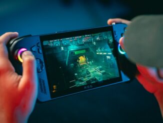 Person playing a video game on a handheld device.