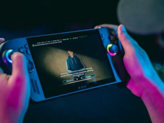 Person holding a portable gaming console playing a video.
