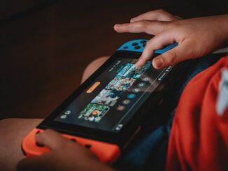person playing nintendo game boy