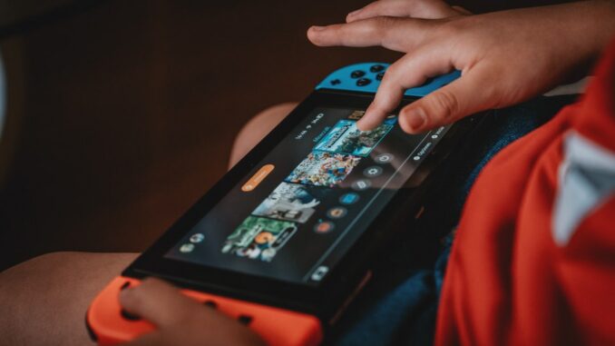 person playing nintendo game boy